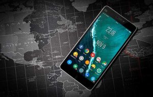 Android smartphone laying on a world map